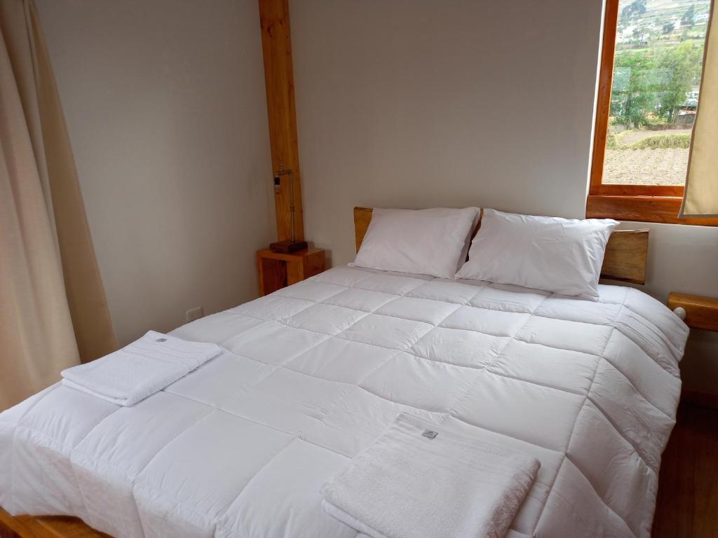 Postel nebo postele na pokoji v ubytování Bonanza Hospedaje