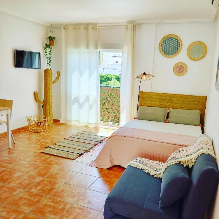a bedroom with a bed and a couch at Agua Amarga Design in Agua Amarga
