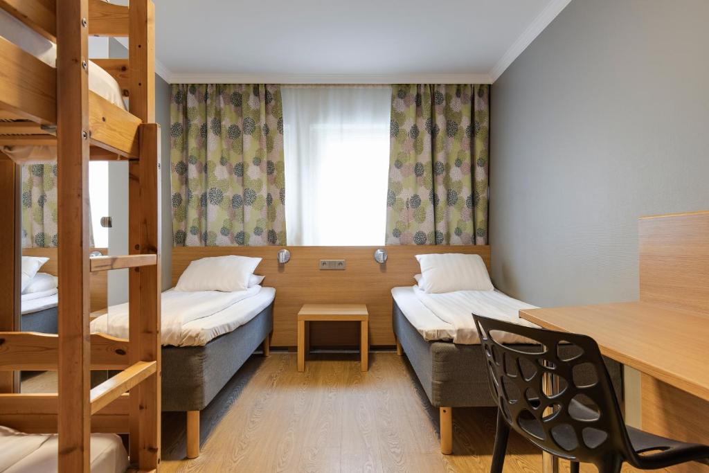 Postel nebo postele na pokoji v ubytování Göteborgs Mini-Hotel