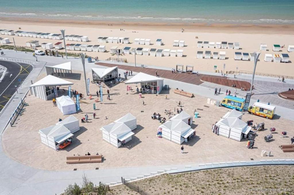 an aerial view of a beach with tents and people at Au Kaycedra in Calais