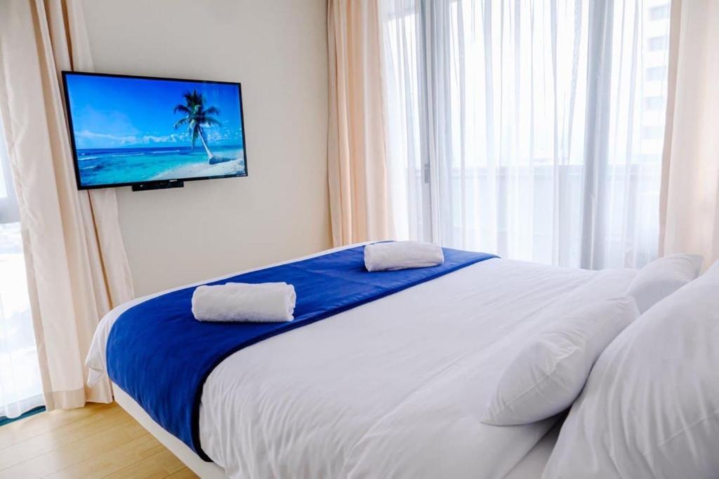 Postel nebo postele na pokoji v ubytování G-Point City Beach