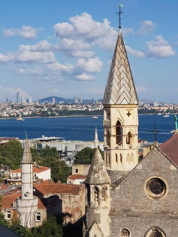 een oude kerk met een torenspits bovenop een stad bij Ali Pasha Apartment in Istanbul
