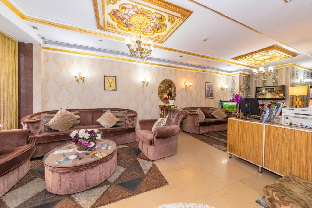 a living room with couches and a table at Ista Palace Hotel in Istanbul