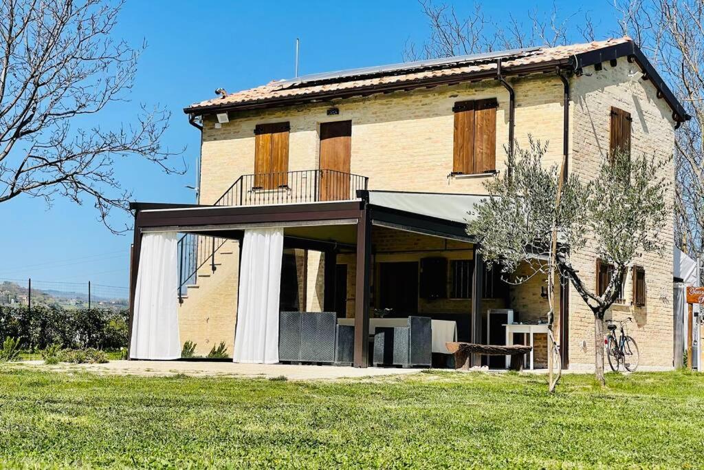 an old house with a balcony on the side of it at Alpaca Village - Angolo di Paradiso in Colli del Tronto