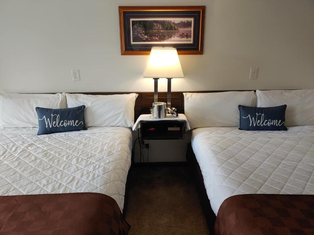 Iron River的住宿－Lakeshore Motel Ice Lake，酒店客房,设有两张床和一盏灯