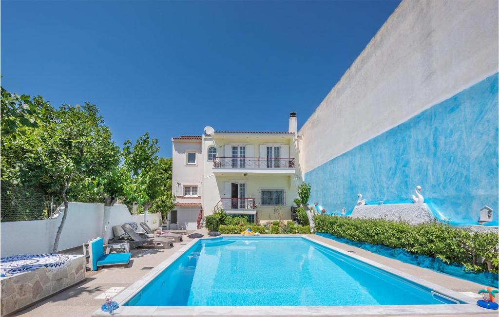 a swimming pool in front of a house at Amazing Home In Lechaio Corinthias With Wifi in Lechaio