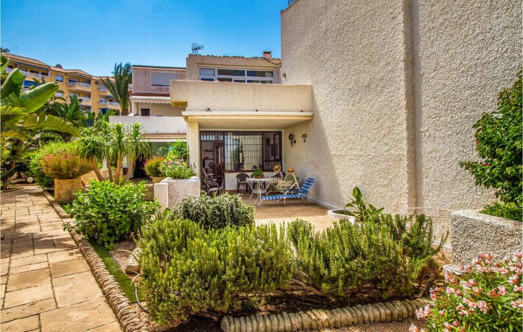 a house with a courtyard with plants in front of it at Awesome Apartment In Playa Honda With Kitchen in Playa Honda