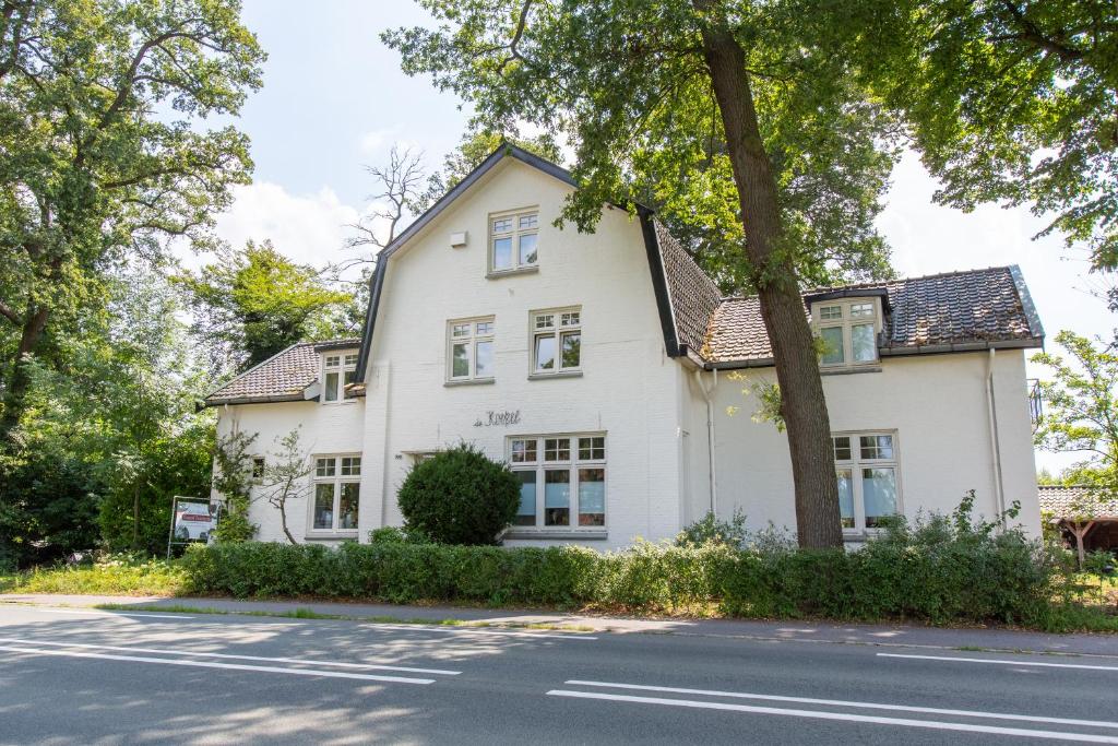 a white house on the side of a street at Koepel Enschede in Enschede