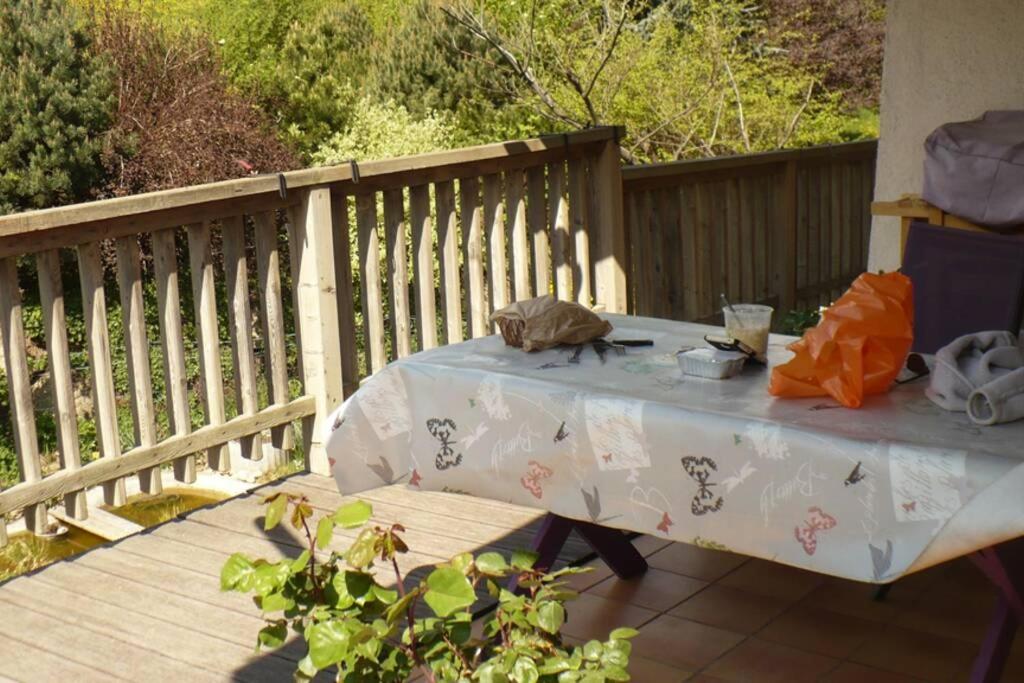 a table on a deck with a table cloth on it at Le chalet de Julbert in Combloux
