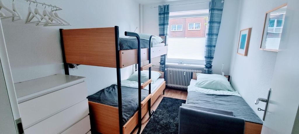 a small room with two bunk beds in it at Fewo-Alter PlusSize in Wilhelmshaven