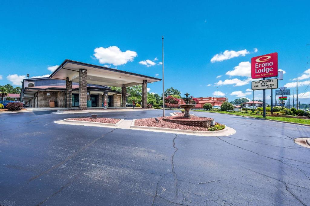 a gas station with a for sale sign in front of it at Econo Lodge Inn & Suites University in Huntsville