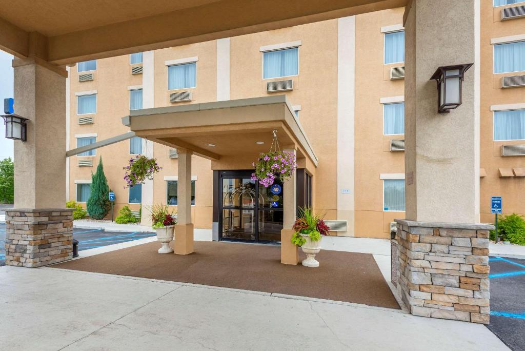 a building with a entrance with flowers in front at Comfort Inn & Suites Wilkes Barre - Arena in Wilkes-Barre