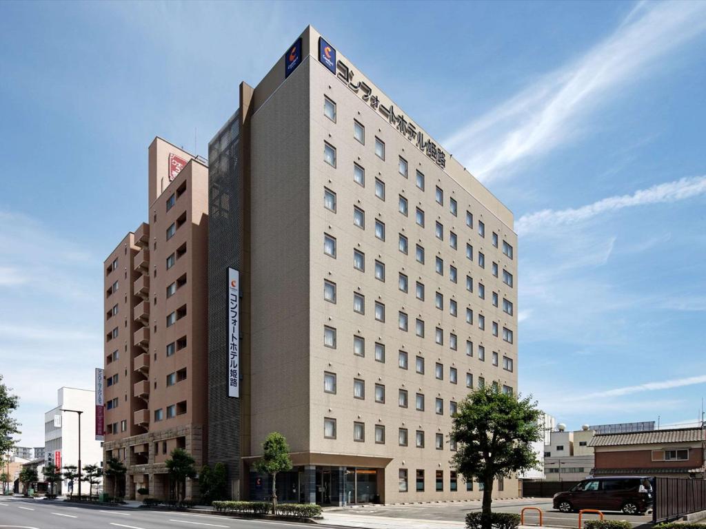a large building on the corner of a street at Comfort Hotel Himeji in Himeji
