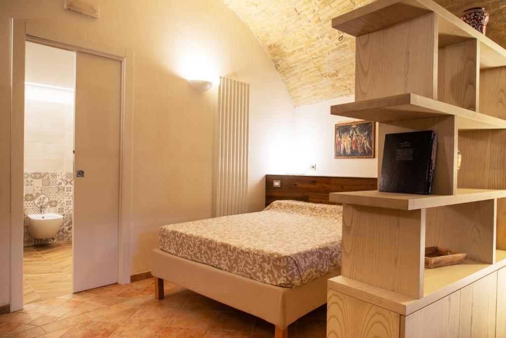 Postel nebo postele na pokoji v ubytování Camere Capobove Assisi