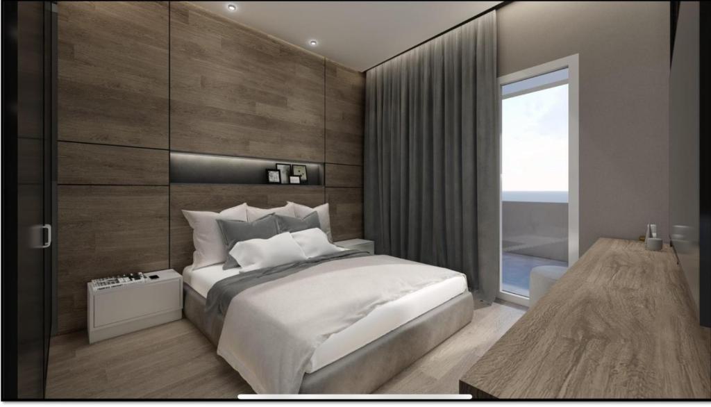 a bedroom with a large bed and a large window at Luxury Townhouse Suite in Larisa