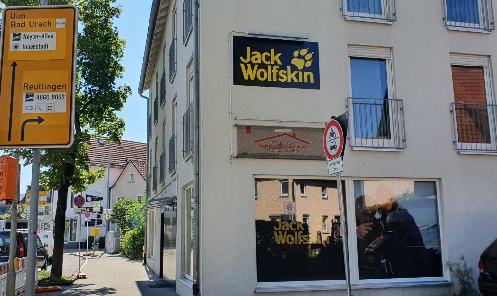 a store with a sign on the side of a building at Outletcity Ferienwohnung Wohnung 2 in Metzingen