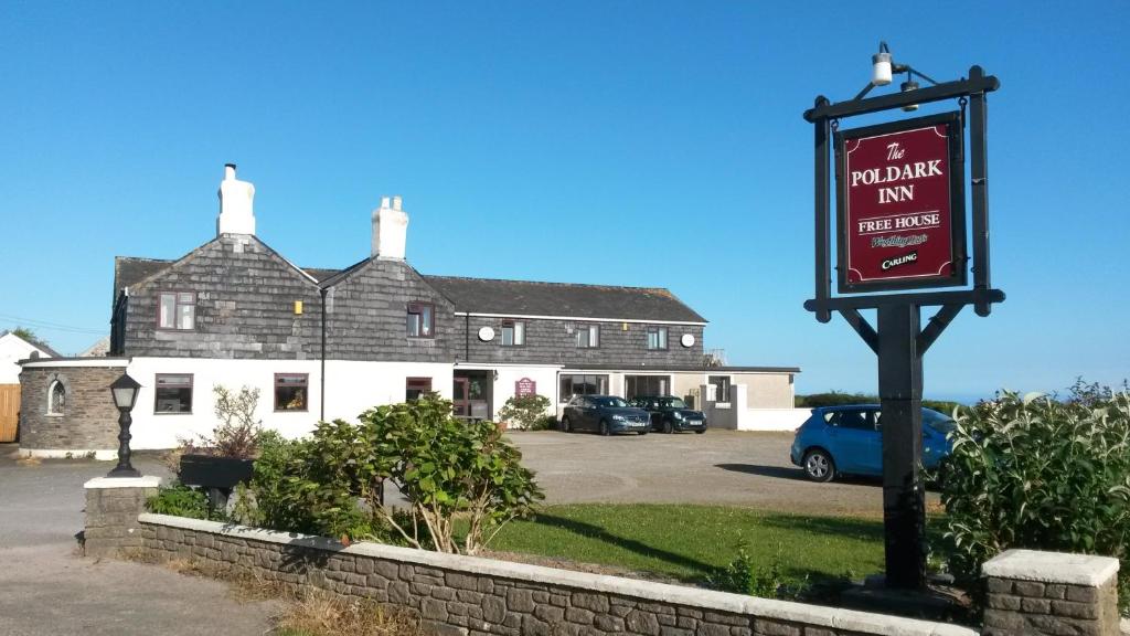 un cartello per una locanda per la sosta delle bevande di fronte a un edificio di The Poldark Inn a Delabole