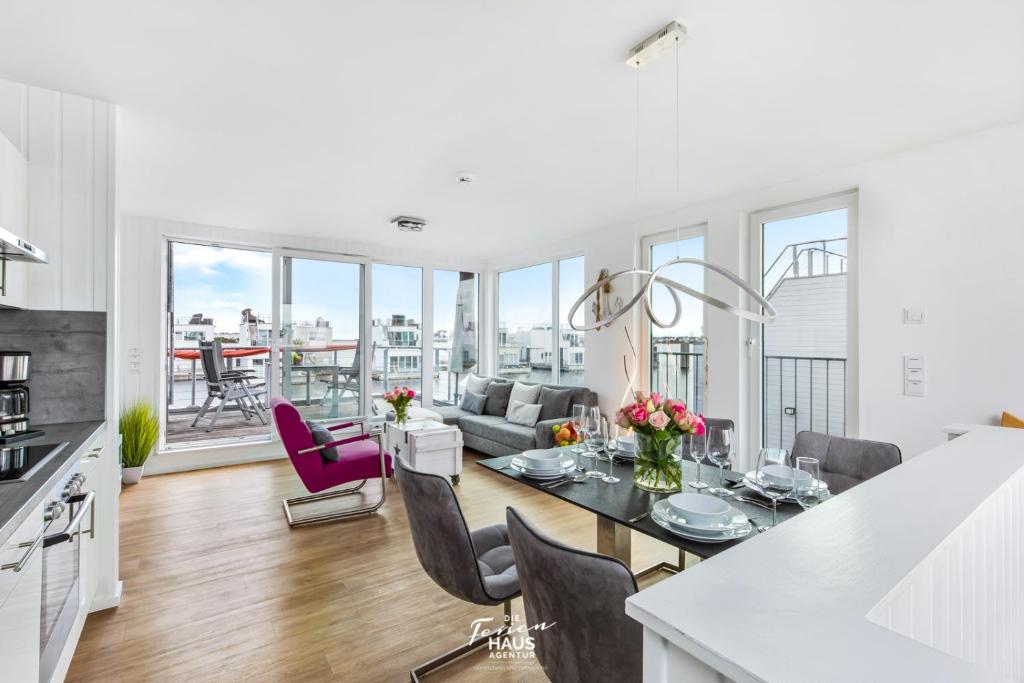 a kitchen and living room with a table and chairs at Ankerplatz19b in Olpenitz