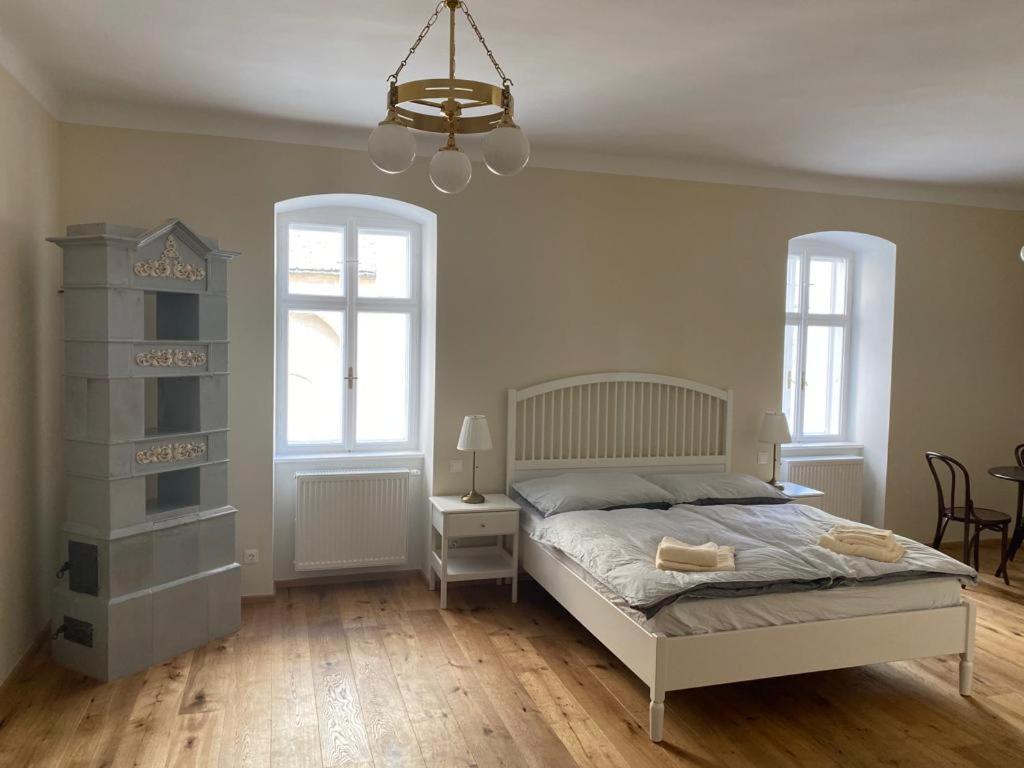 a bedroom with a bed and a chandelier at Alte Seifensiederei zu Pulkau Ferienwohnung in Pulkau