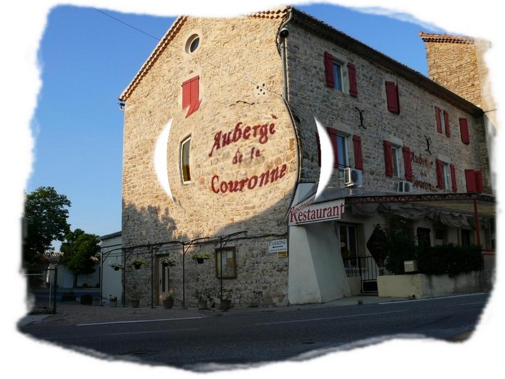 a building with a sign on the side of it at Auberge de la Couronne in Lablachère