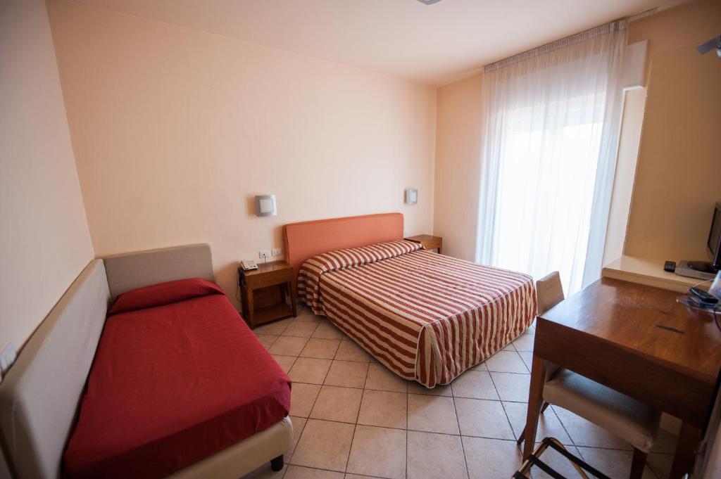 Postel nebo postele na pokoji v ubytování Alba Hotel