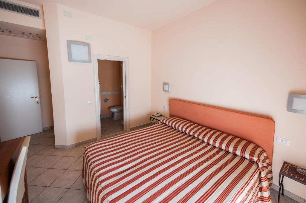 Postel nebo postele na pokoji v ubytování Alba Hotel