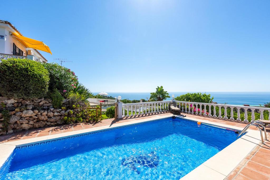 a swimming pool with a view of the ocean at Villa Magica Andalucian charm in Benalmádena