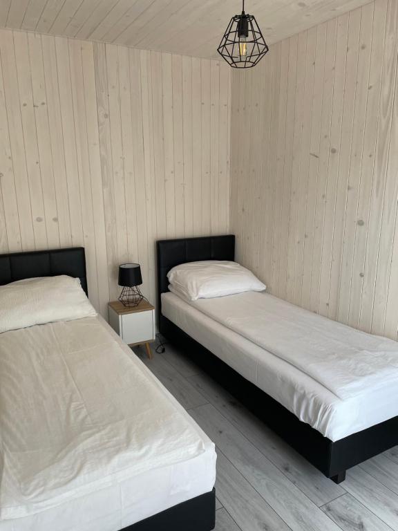 Postel nebo postele na pokoji v ubytování Domki Norda II