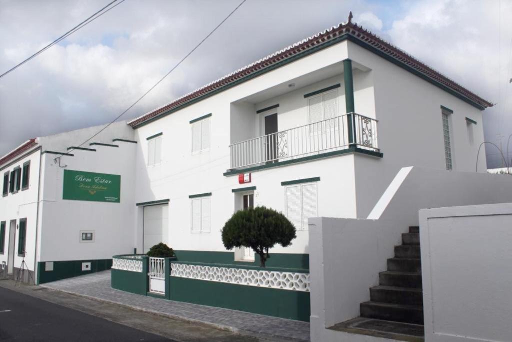 a white building with a staircase in front of it at Bella Italia Bem Estar Dona Adelina in Ponta Garça