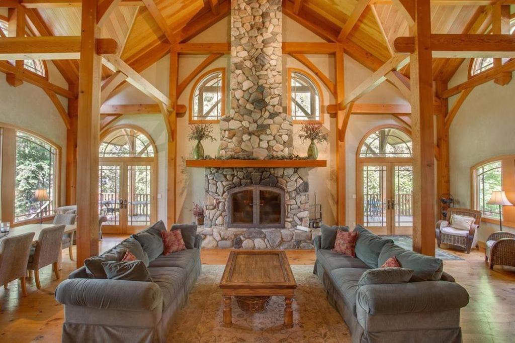 a living room with a couch and a fireplace at Snowgrass Lodge - River, Mountain Views & Hot tub in Leavenworth