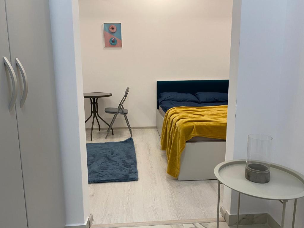 Dormitorio pequeño con cama y mesa en STUDIO PALAS - the central spot, en Iaşi