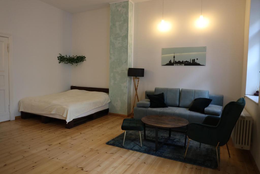 ein Wohnzimmer mit einem Sofa und einem Bett in der Unterkunft Apartment Lodge 61 in Berlin