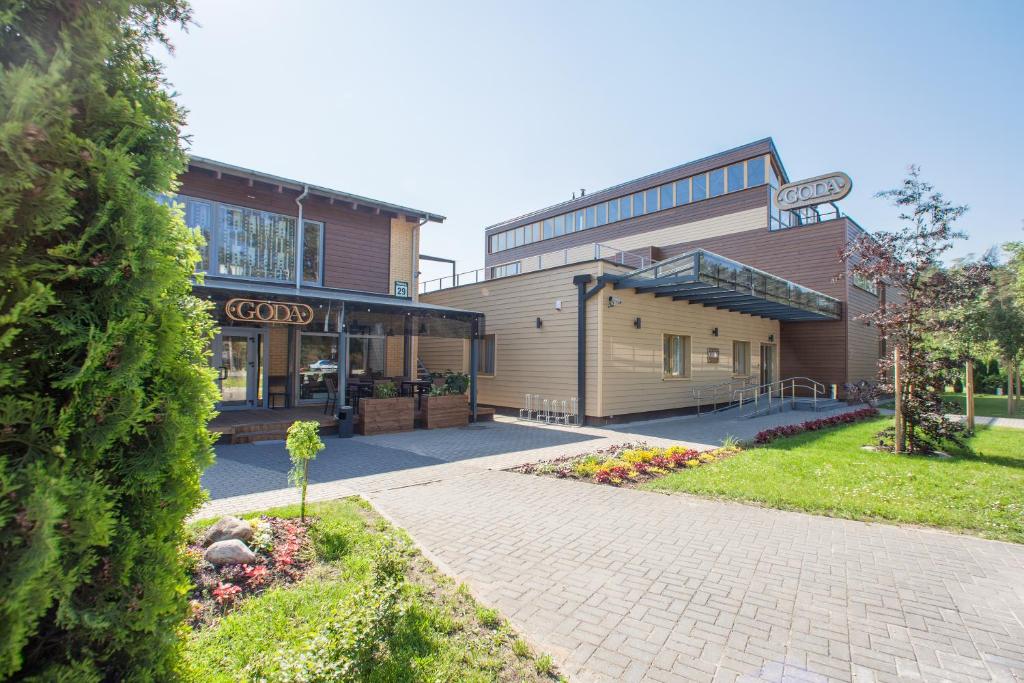 a building with a sidewalk in front of it at Goda Hotel & Spa in Druskininkai