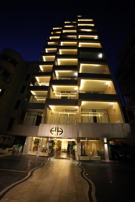 a tall building at night with a street in front at Holiday Home Suites in Beirut