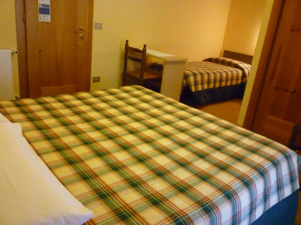 Postel nebo postele na pokoji v ubytování Hotel I Rododendri