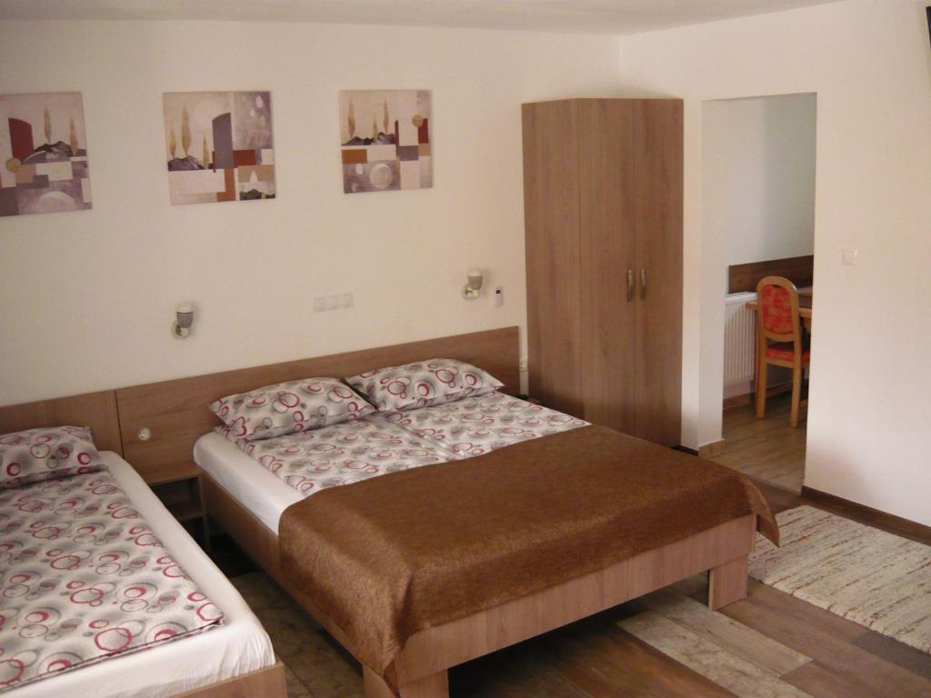 a hotel room with two beds and a mirror at CASA DE OASPETI LIVIU in Praid