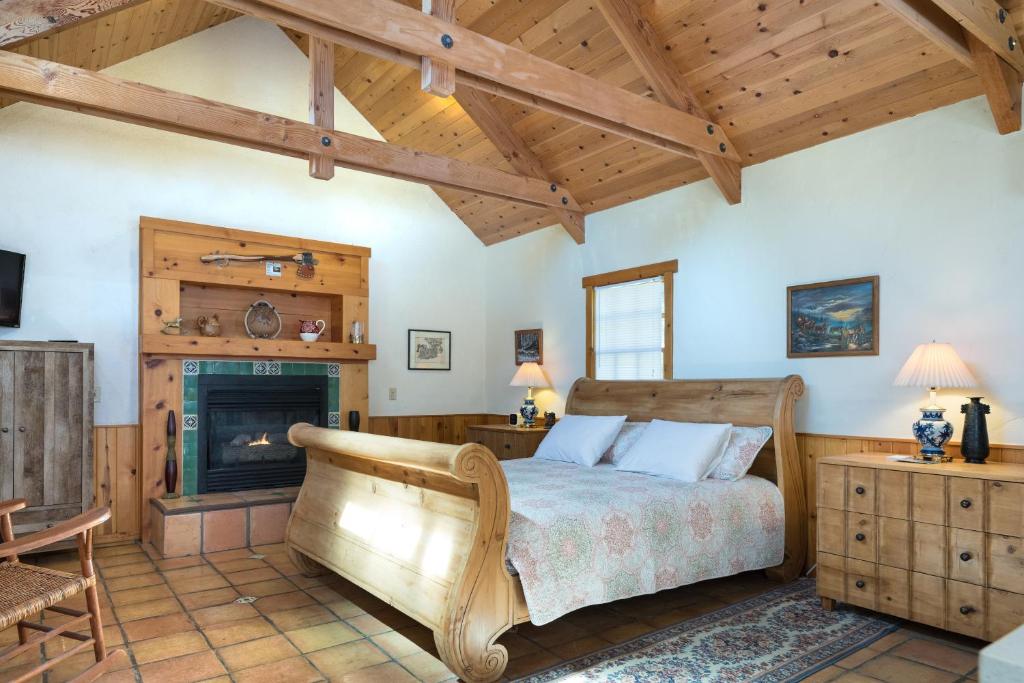 a bedroom with a bed and a fireplace at Homestead Cottages in Ahwahnee