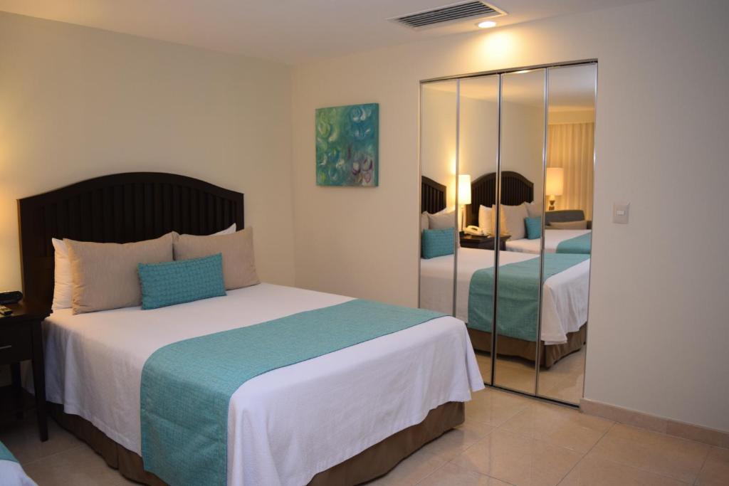 Postel nebo postele na pokoji v ubytování Astur Hotel & Residence