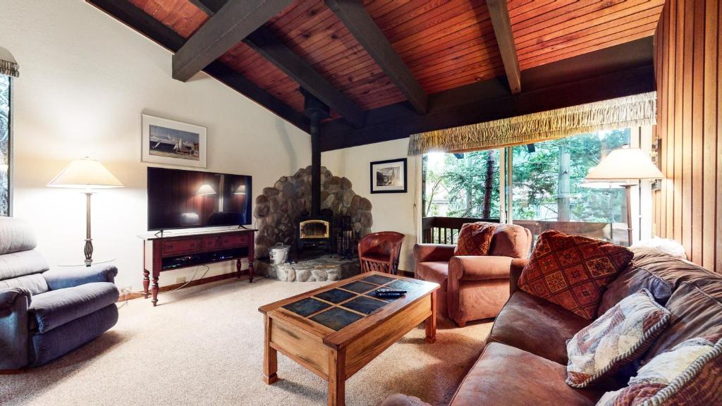 a living room with a couch and a table at Mammoth West #101 Condo in Mammoth Lakes
