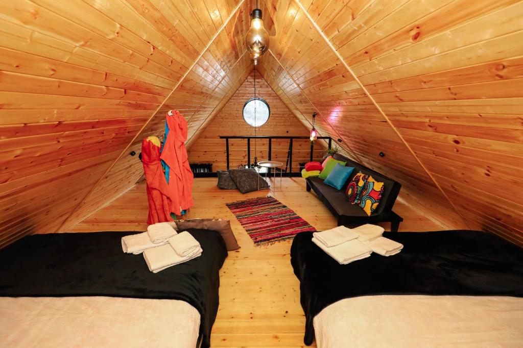 a room with two beds in a log cabin at Wooden cottage "green house" in Bakuriani in Bakuriani