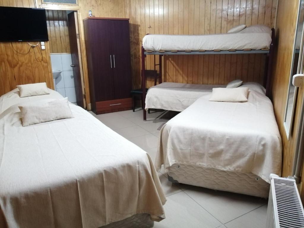Postel nebo postele na pokoji v ubytování Hostal Copiapó Puerto Montt