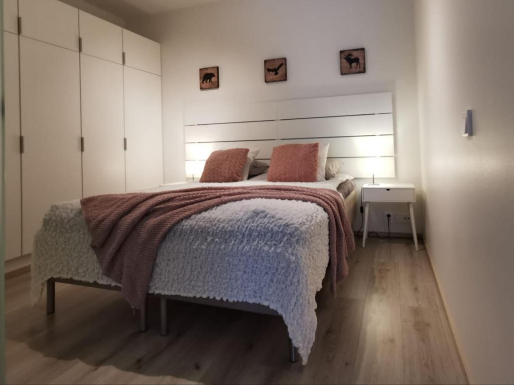 a bedroom with a large bed and a night stand at Rovaniemi Cityhome Nordica in Rovaniemi