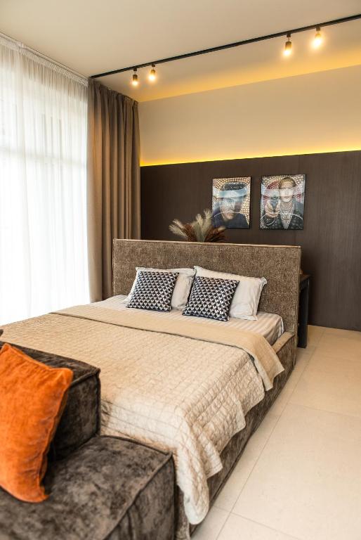 a bedroom with a large bed and a couch at Пентхауз с террасой район Мост Сити in Dnipro