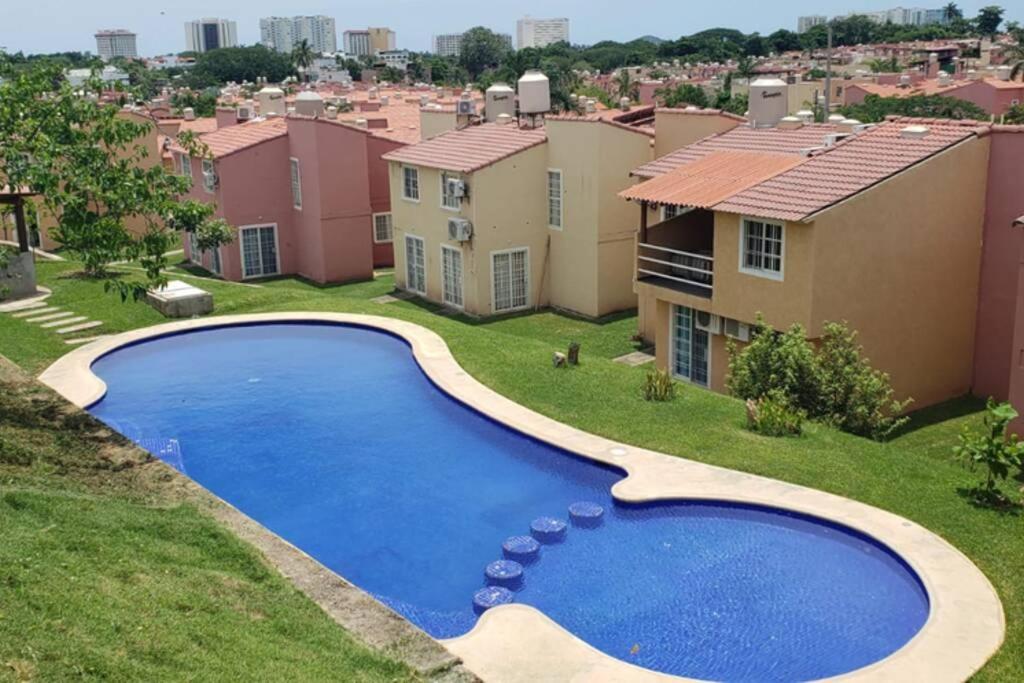 an image of a swimming pool in front of a house at Nueva Casa de playa Brisas del Mar in Ixtapa