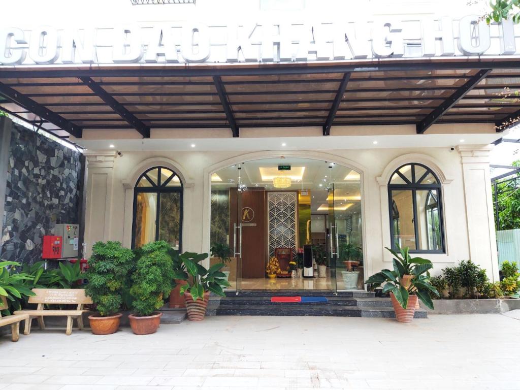 a store front with potted plants in front of it at KHANG HOTEL CON DAO in Con Dao