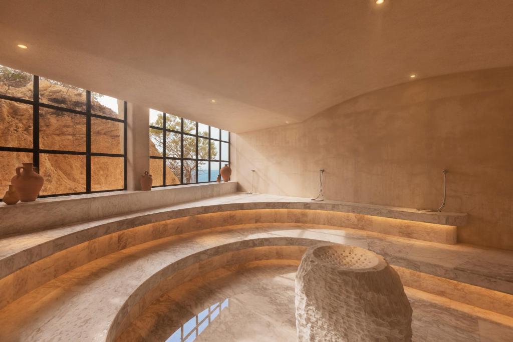 a circular room with a stone bowl in the middle at Six Senses Ibiza in Portinatx