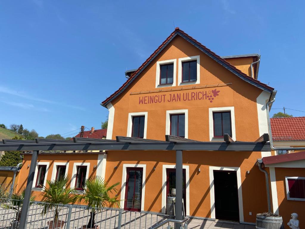 a building with a sign on the side of it at Weingut Jan Ulrich in Diesbar-Seusslitz