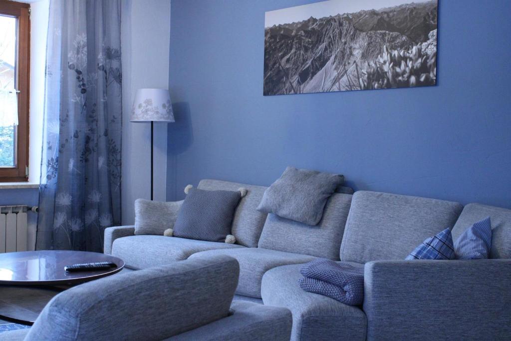 - un salon bleu avec un canapé et une table dans l'établissement Ferienwohnungen Sternkopf, à Immenstadt