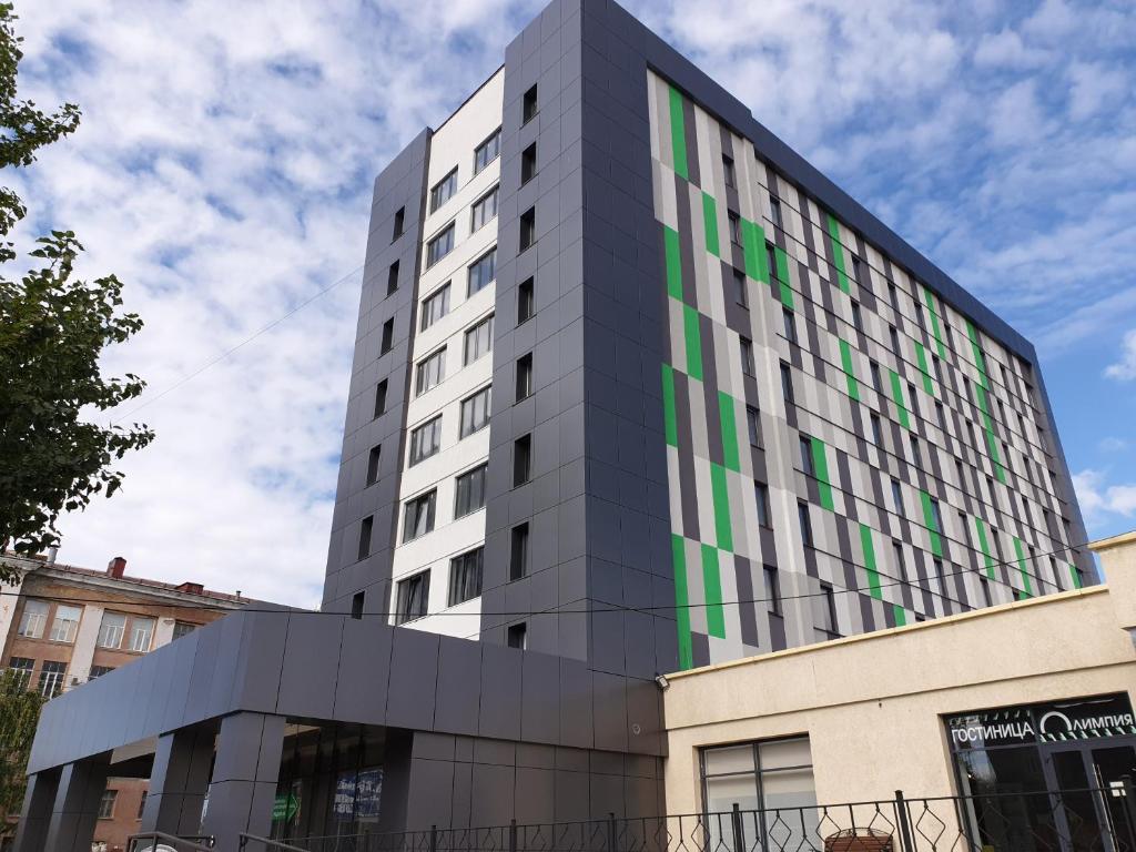 a tall building with green and gray at Гостиница Олимпия после реновации in Saratov