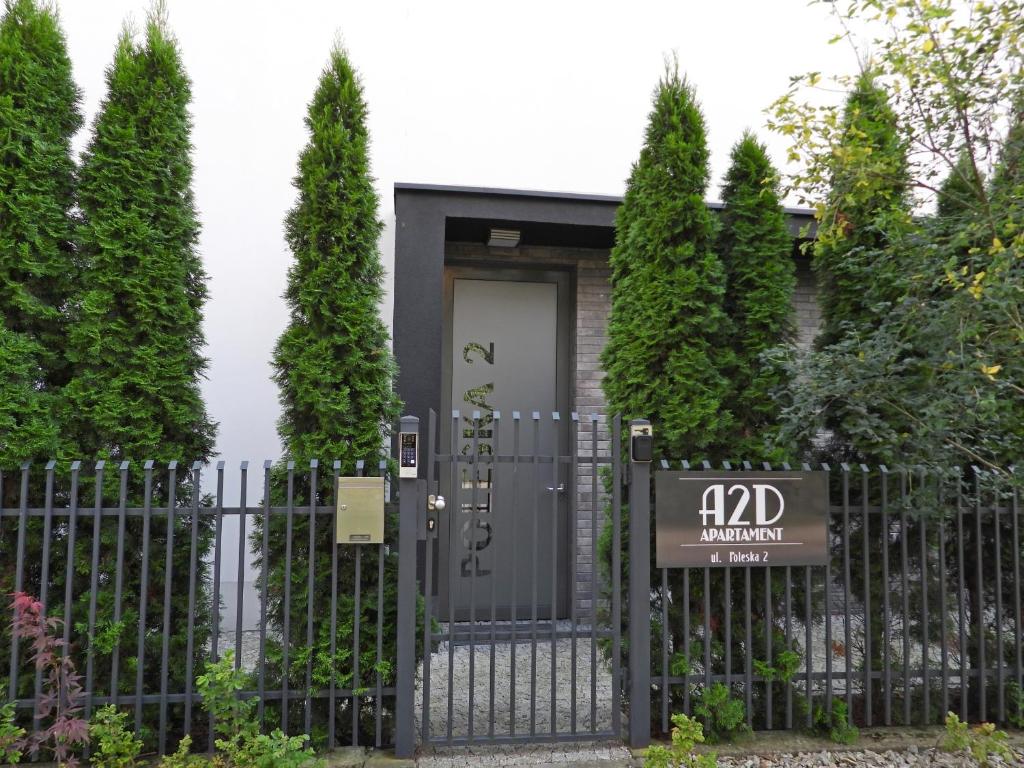 a black gate with a sign in front of a house at Apartament A2D Kraków in Krakow